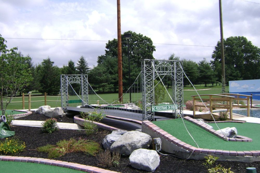 Golf course hole with a bridge structure